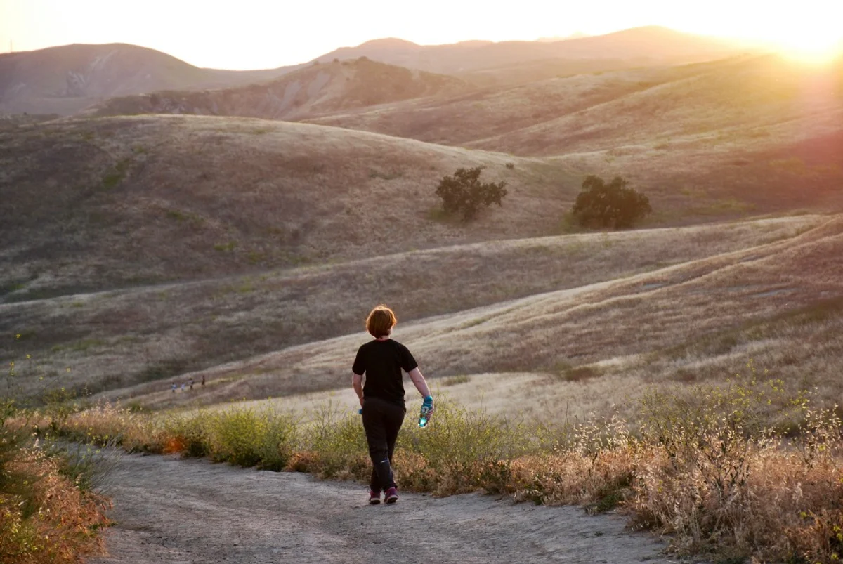 Person walking outdoors to track daily steps